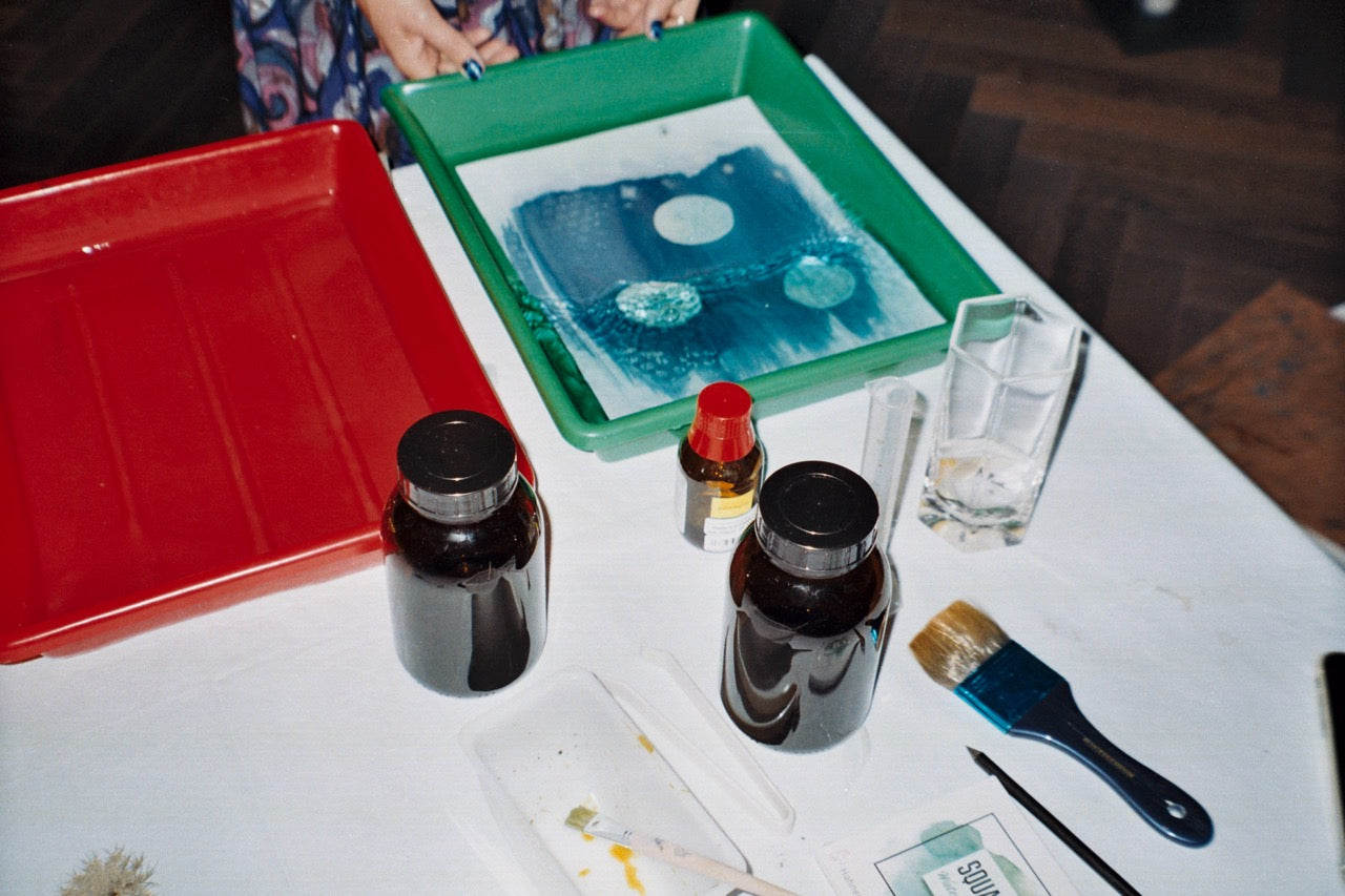 cyanotype workshop with chemicals on table